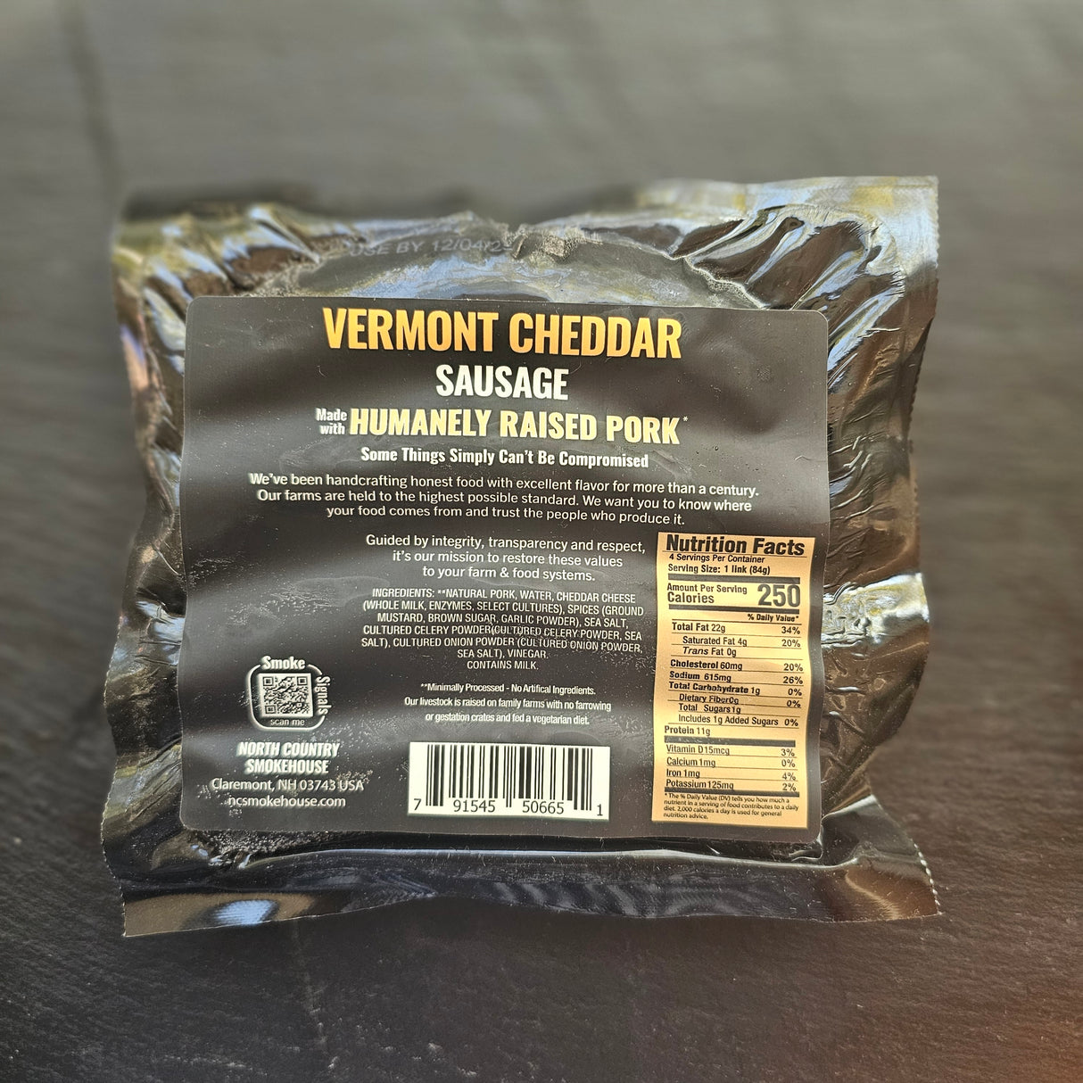 Back of a Vermont Cheddar Sausage package on a dark surface