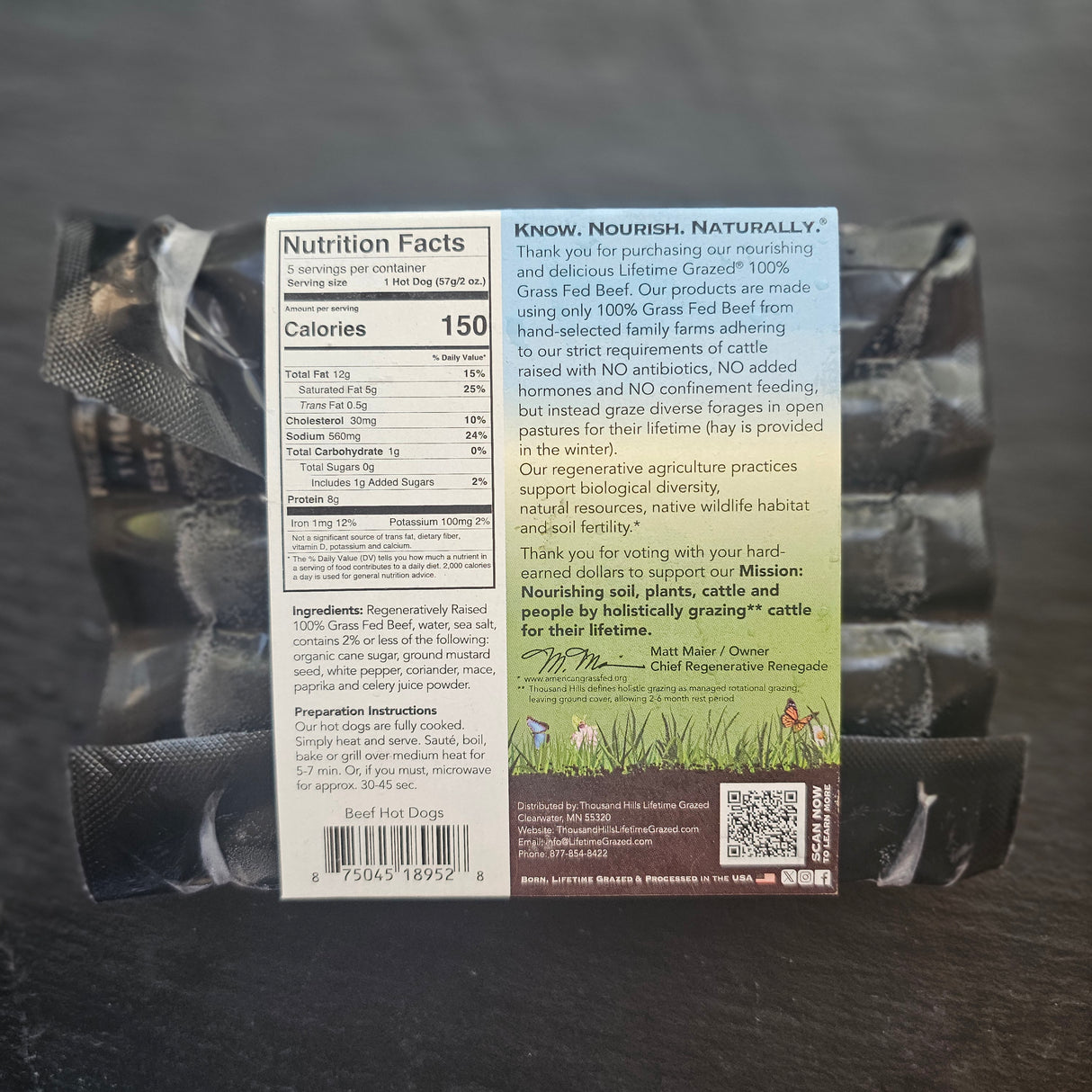 Back of a pet food package with nutritional information on a dark surface