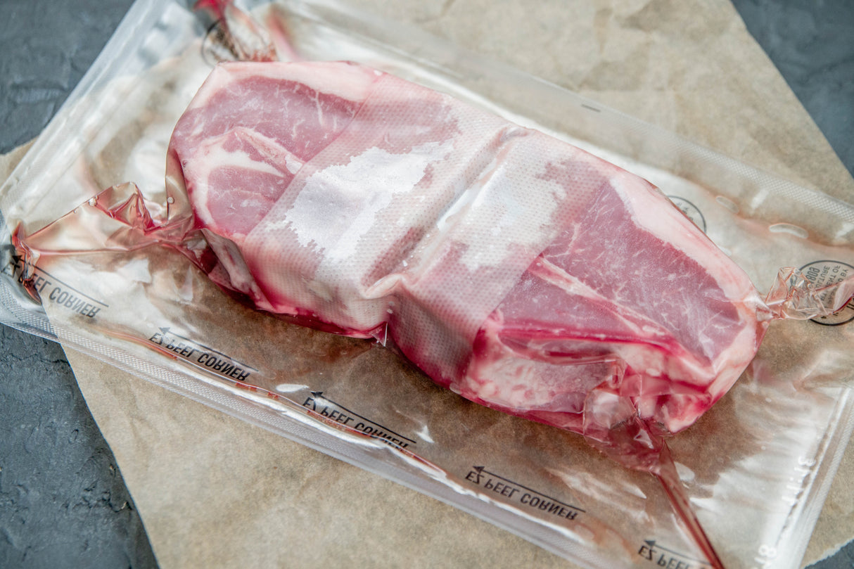 Raw meat package on a gray surface