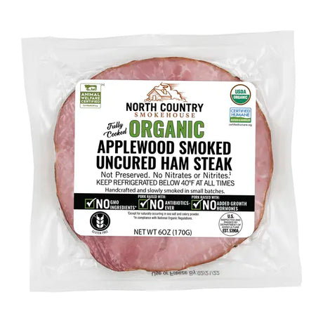 Packaged organic applewood smoked uncured ham steak with North Country Smokehouse label on a white background