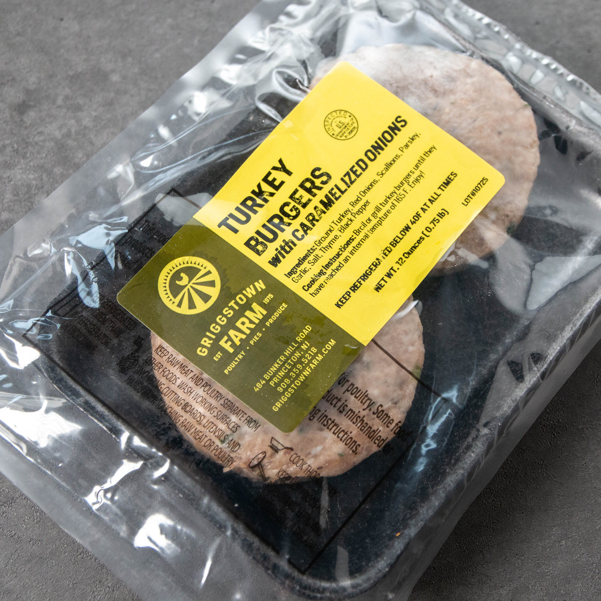 Packaged turkey burgers with a label on a gray surface