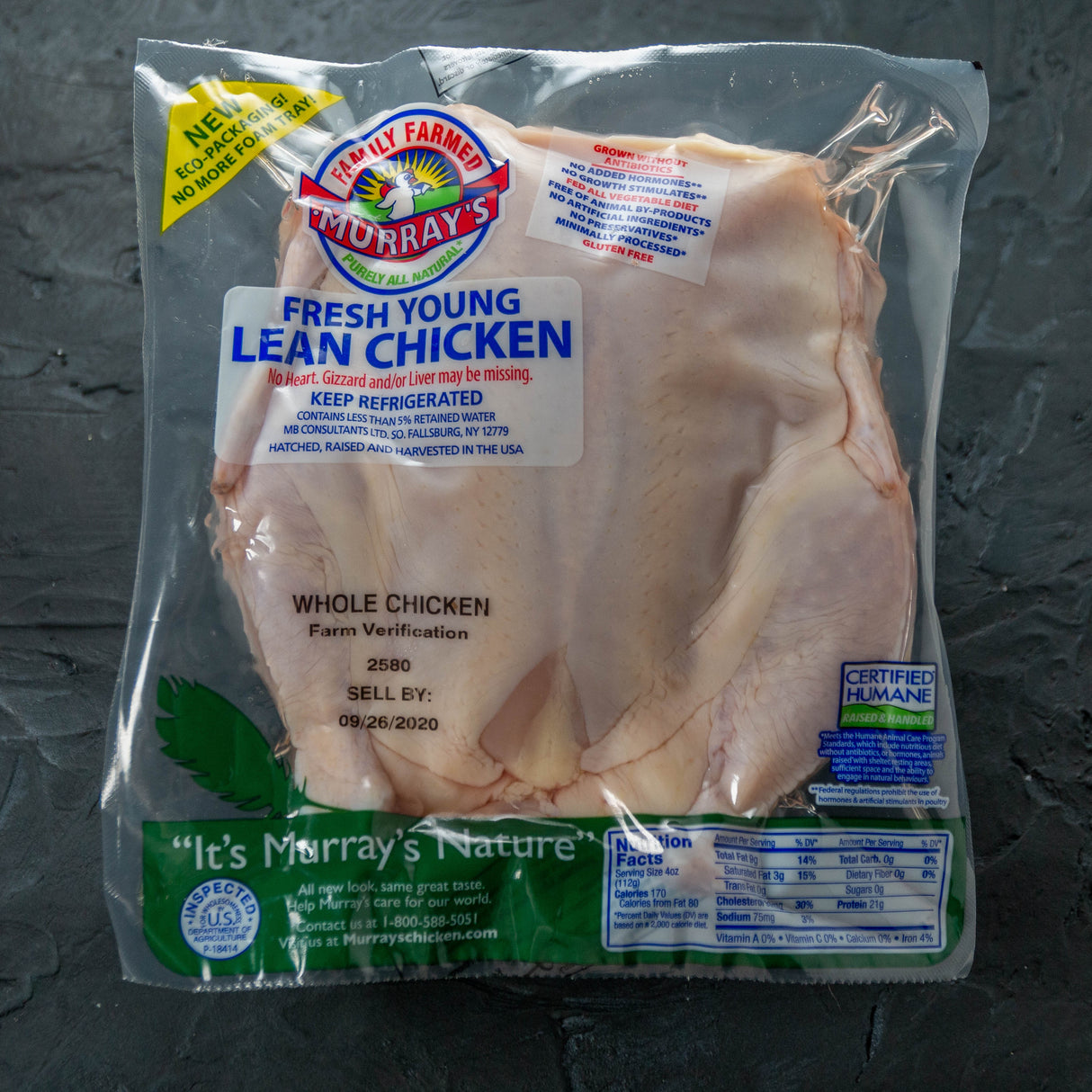Packaged whole chicken with Murray's Fresh label on a dark surface