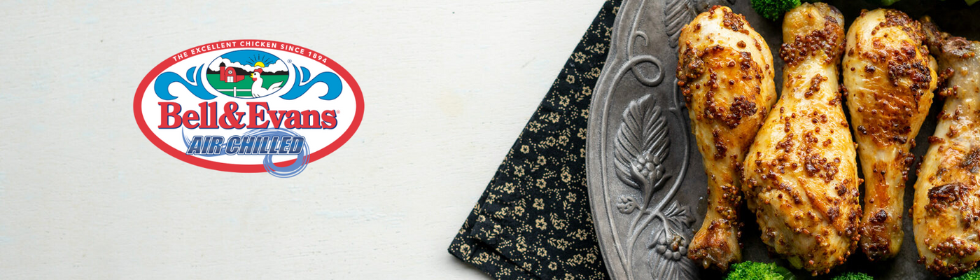 Bell & Evans all-chicken logo with roasted chicken legs on a platter.