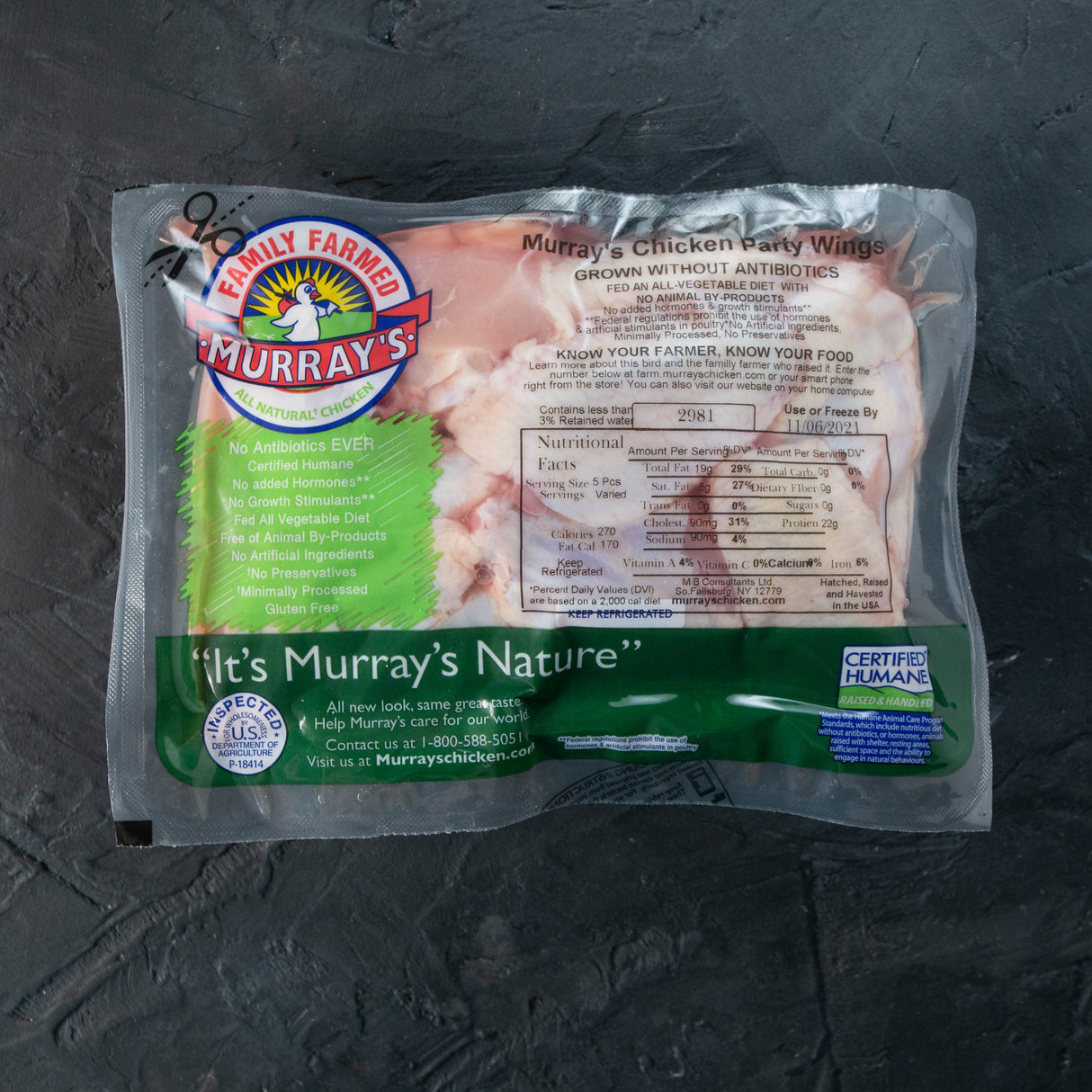 Packaged Murray's chicken wings on a dark surface