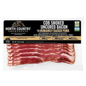 Package of North Country Smokehouse cob smoked uncured bacon on a white background