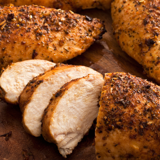 cooked chicken breast with seasoning and sliced