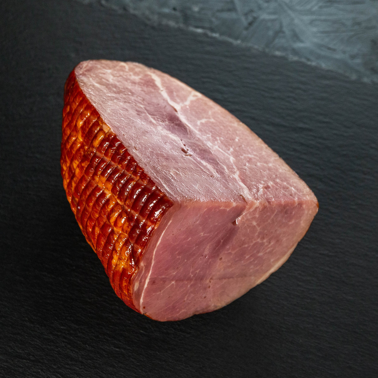 Slice of cured meat on a dark surface